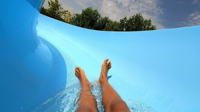 Teenager Boy Have Fun In A Closed Slider At Water Park. Fun On Water. Enjoying Water Slider Ride. Rider POV. Point Of View In Aqua Park Tube Slide. Summer Time. Multicolors View