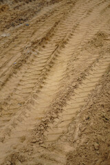 Tire track on yellow sand. Construction, repair of the street, roads.