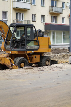 .Construction and repair of the road. City street. Tire tracks in the sand, building materials.
