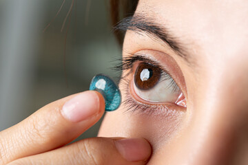 Close up Young asian woman with contact lens. Medicine and vision concept