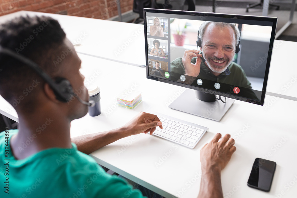 Poster African american businessman discussing with colleagues while video conferencing over computer