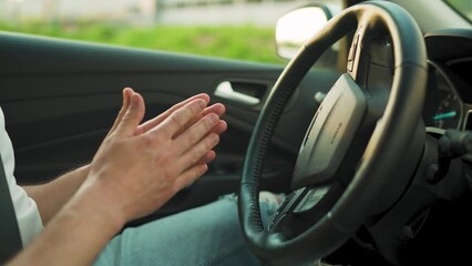 Man driving in innovative automated car using self-parking autopilot for parking on parking lot