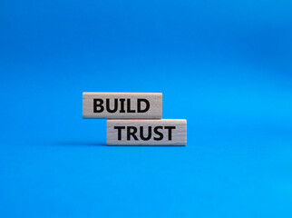 Build trust symbol. Wooden blocks with words Build trust. Beautiful blue background. Business and Build trust concept. Copy space.