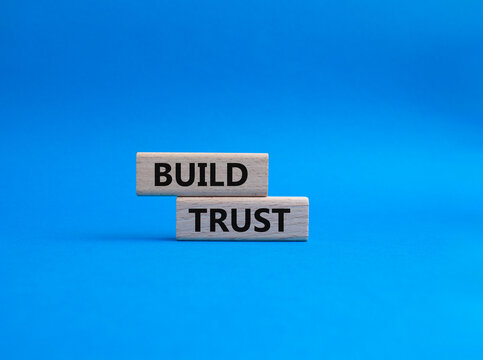 Build trust symbol. Wooden blocks with words Build trust. Beautiful blue background. Business and Build trust concept. Copy space.