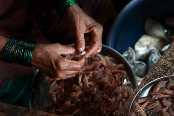Close up of woman's cleaning the prawns for cooking.