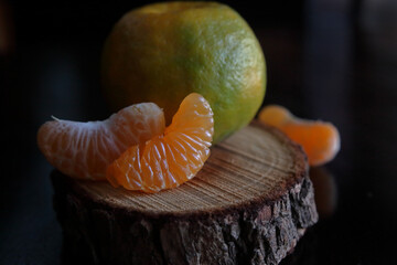 Close up shot of slice of an orange fruit in window lighting.