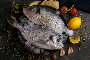 Raw dorado fish with spices cooking on cutting board.