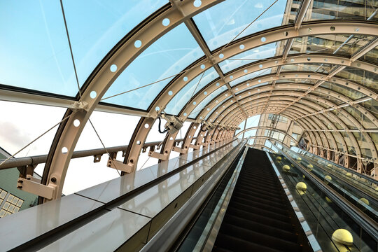 Glass Tunnel Escalator Looking Up.Steel Bone Cement.Metal Industry