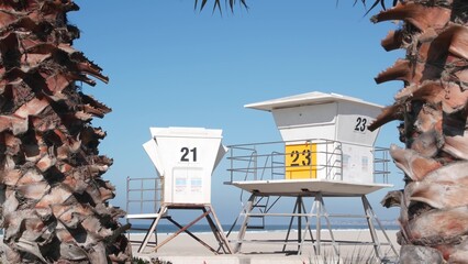 Lifeguard stand and palm tree, life guard tower for surfing on California beach. Summer pacific...