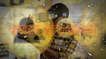 Animation of stay at home text and data processing over african american man with vr headset - Powered by Adobe