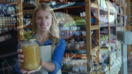 Animation of data processing over happy caucasian female shopkeeper holding jar of honey in shop - Powered by Adobe