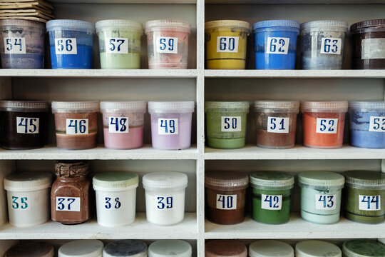 Jars with paints on the shelves