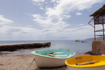 colored boats on empty beach