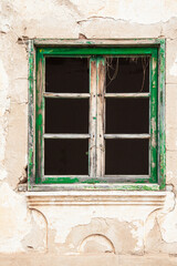 Fototapeta na wymiar green wooden window in abandoned house