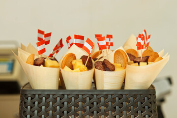 Cones filled with a variety of cheese, sausages, salami and olives at the farmers street food market