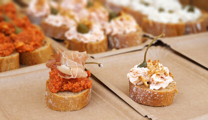 Freshly prepared canapés on the stall attract visitors to the farmers street market.