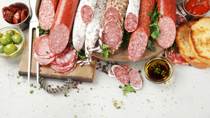 Sausages salami assortment on light background.