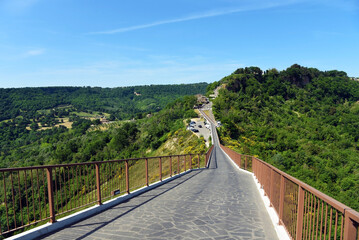 bridge that connects bagnoregio to the village of civita traveled on foot by numerous tourists Civita di Bagnoregio Italy