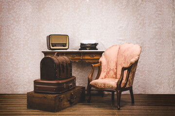 Set of old vintage suitcases, typewriter, armchair and radio.