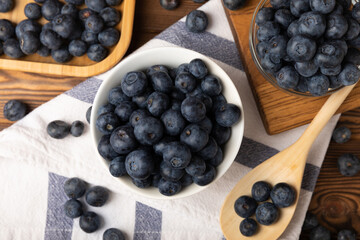 Blueberries in a ceramic bowl on a brown textural background. Ripe and fresh blueberries. Vitamins. Healthy food. Juicy berry.Copy space.Place for text