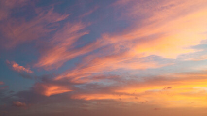 Dramatic sunset sky with evening sky clouds lit by bright sunlight