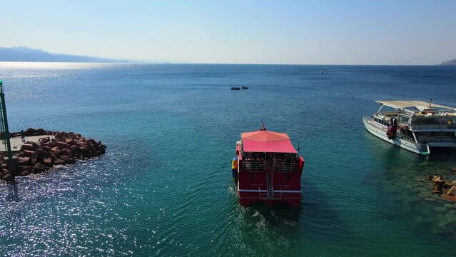 Aerial Shot Of Red Passenger Ship Moving In Red Sea On Sunny Day - Eilat, Israel