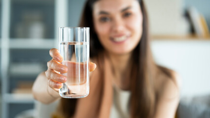 Young woman drinks a glass of water - 510460724