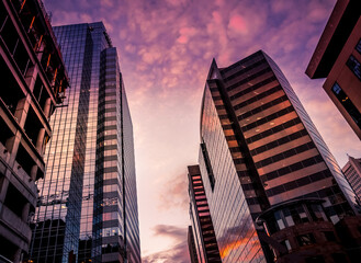Tall office skyscrapers with sunset background. - 510461184