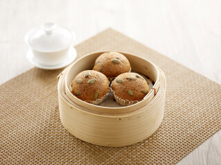 Japanese Brown Sugar Sponge Cake served in a wooden bowl isolated on mat side view on grey background