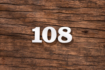 Number 108 - piece on rustic wood background - obrazy, fototapety, plakaty