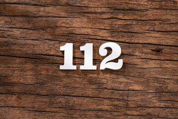 Number 112 - piece on rustic wood background