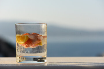 Gin and tonic with grapefruit and orange, overlooking the sea in Greek Island Hydra