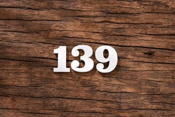 Number 139 in wood, isolated on rustic background