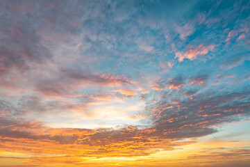 Dramatic sunset sky with evening sky clouds lit by bright sunlight