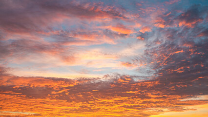Dramatic sunset sky with evening sky clouds lit by bright sunlight