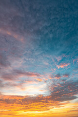 Dramatic sunset sky with evening sky clouds lit by bright sunlight