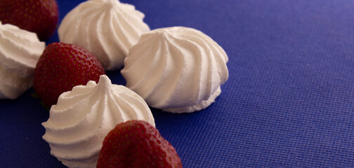 bizet with strawberries on a blue background close-up