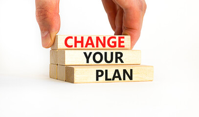 Change your plan symbol. Concept words Change your plan on wooden blocks on a beautiful white table white background. Businessman hand. Business, finacial and change your plan concept. Copy space.