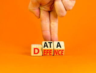 Data defence symbol. Concept words Data defence on wooden cubes. Beautiful orange table orange background. Businessman hand. Business and cyber crime concept. Copy space.