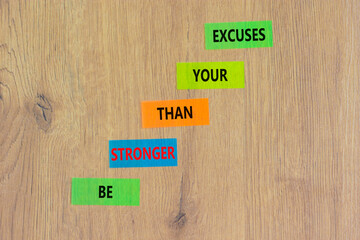 Be stronger symbol. Concept words Be stronger than your excuses on colored paper on a beautiful wooden table wooden background. Copy space. Business motivational and be stronger concept.