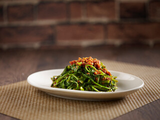 Sauteed Kang Kong with Sambal served in a dish isolated on mat side view on dark background