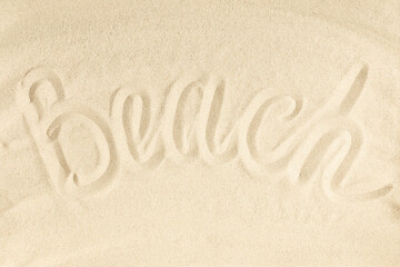 Summer beach writing vacation concept. Word Beach written on sand. Flat lay, top view