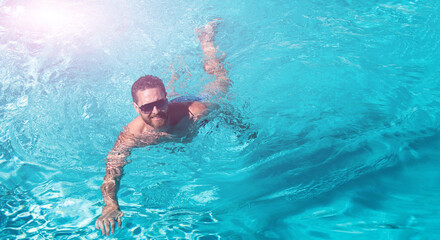 Man at summer vacation. Guy in sunglasses swimming in pool. Summertime pool resort. Banner for design header, copy space.