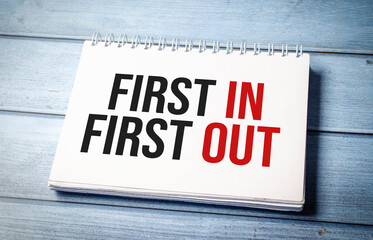 FIFO First in, first out word notebook on wooden background