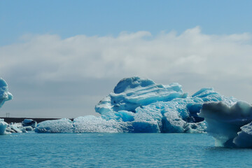 Bright clear blue iceberg floating in the Jokulsarlon lake blue cold water in Iceland 22