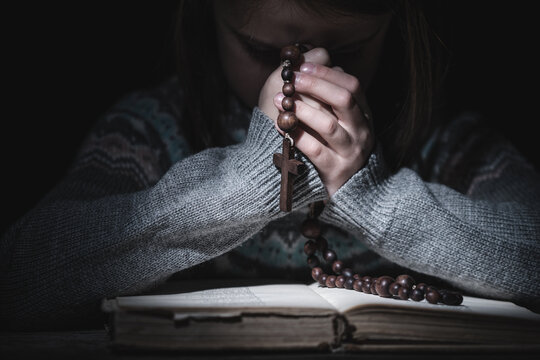 Prayer To God. Close Up Portrait Of Young Girl Pray With Rosary And Reading The Bible. Horizontal Image.