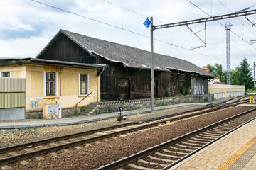 Fototapeta na wymiar Old wooden station building next to the tracks