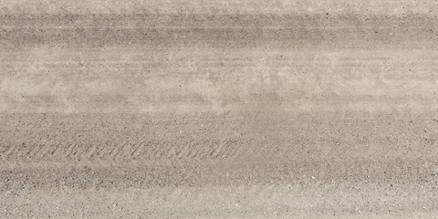 panorama of surface from above of gravel road with car tire tracks