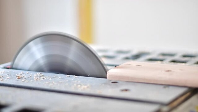 Saw blade cutting wood, construction carpentry industry, building theme.