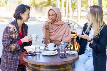Diverse women having lunch in city